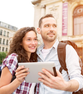 Tourist couple using a tablet with virtual tour application
