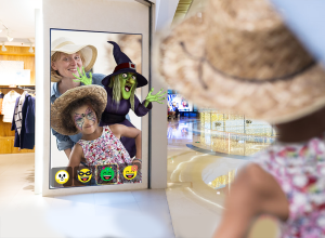 Mother and child using selfie application in shopping center